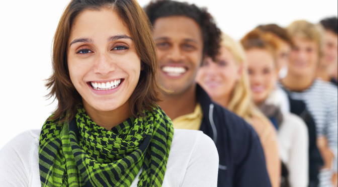 Happy pretty young girl with friends in the background